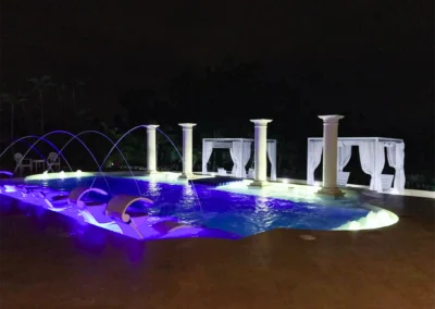 custom pool at night with columns