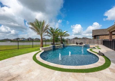 a pool with a tanning ledge and bubblers